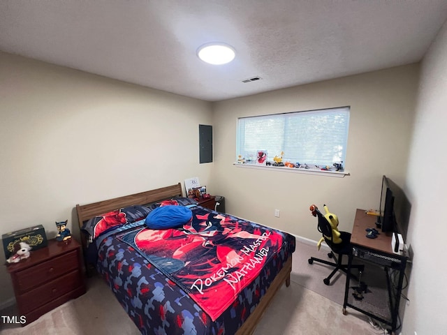 bedroom with electric panel, carpet flooring, and visible vents