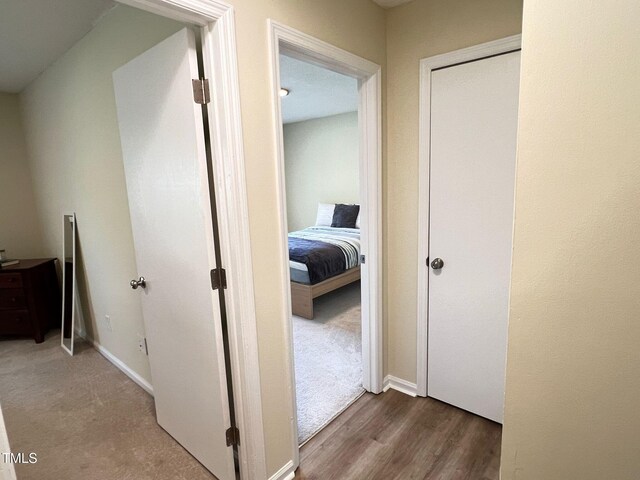 hallway with wood finished floors and baseboards