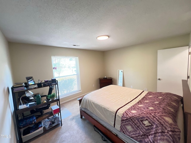 carpeted bedroom featuring a textured ceiling