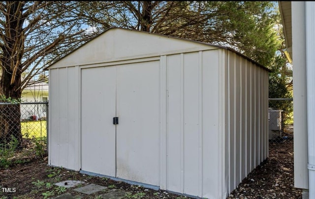 view of shed featuring fence