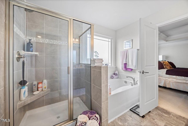 ensuite bathroom featuring ensuite bath, a bath, ornamental molding, and a stall shower