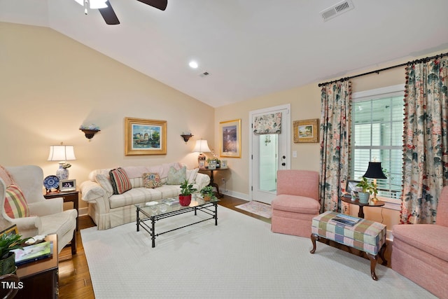 living area featuring lofted ceiling, visible vents, wood finished floors, and ceiling fan