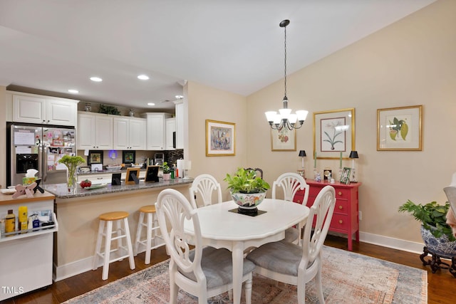 dining room with lofted ceiling, a chandelier, baseboards, dark wood-style flooring, and recessed lighting