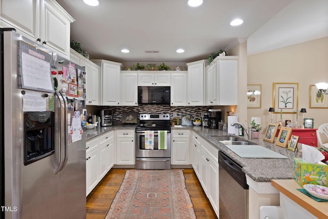 kitchen with stainless steel appliances, wood finished floors, a sink, and white cabinetry