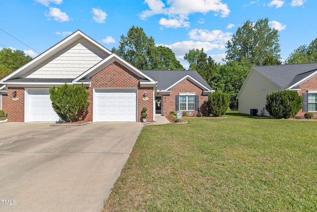 single story home with brick siding, a front yard, a garage, and concrete driveway