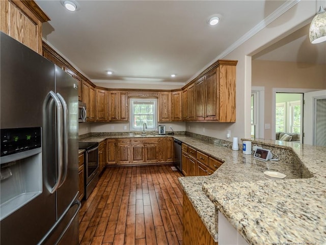 kitchen with ornamental molding, light stone countertops, stainless steel appliances, and brown cabinets