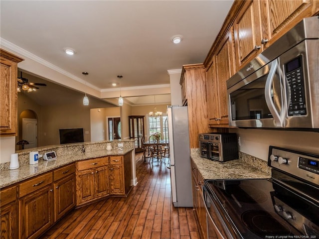 kitchen featuring brown cabinetry, a peninsula, light stone countertops, dark wood finished floors, and appliances with stainless steel finishes