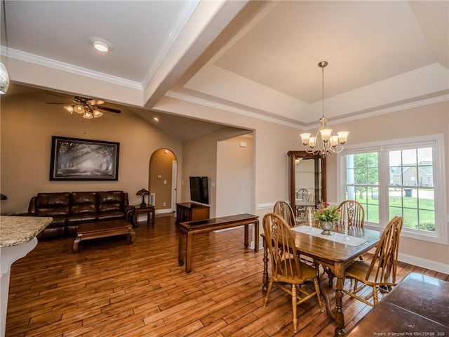 dining space with crown molding, hardwood / wood-style floors, a raised ceiling, arched walkways, and ceiling fan with notable chandelier