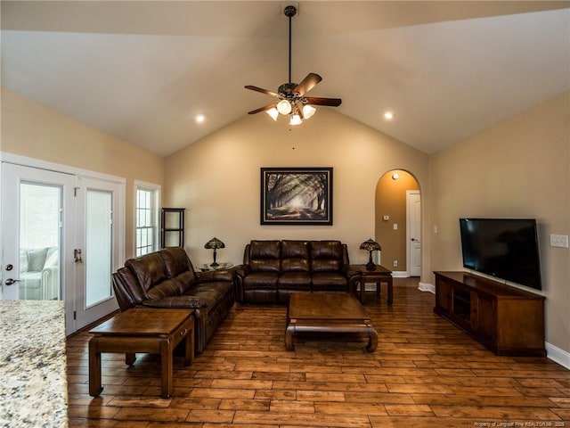 living area featuring wood-type flooring, arched walkways, a ceiling fan, recessed lighting, and lofted ceiling