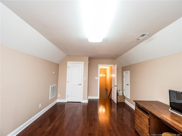 bonus room featuring visible vents, dark wood-type flooring, and lofted ceiling