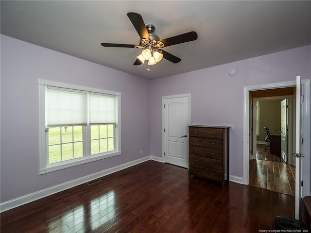 unfurnished bedroom with baseboards, visible vents, ceiling fan, and hardwood / wood-style flooring