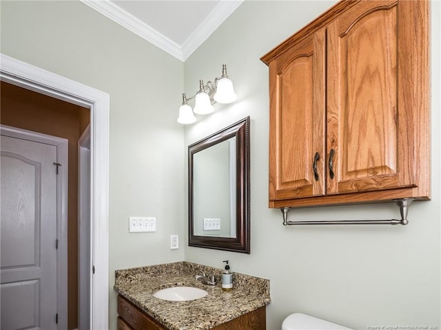 bathroom with vanity, ornamental molding, and toilet