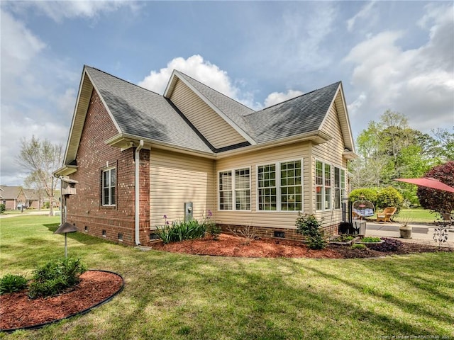 exterior space featuring brick siding, a shingled roof, a patio area, crawl space, and a lawn
