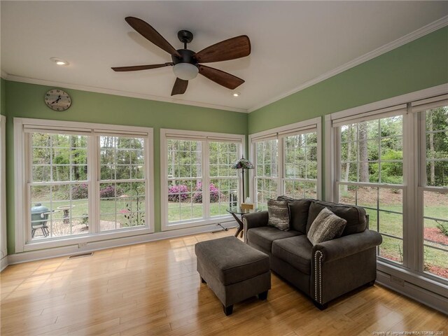 49 Alyssa Ct, Lumberton, NC 28360 - sunroom / solarium with healthy amount of natural light, baseboard heating, crown molding, wood finished floors, and recessed lighting