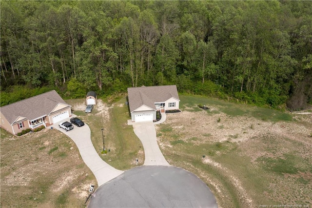 birds eye view of property featuring a wooded view