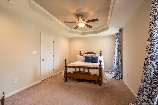 bedroom featuring carpet flooring, ornamental molding, a ceiling fan, and a raised ceiling