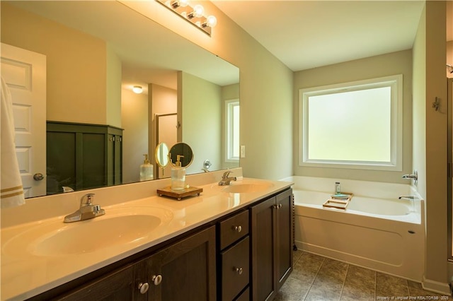 bathroom featuring double vanity, a bath, and a sink