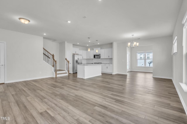 1412 Smoky Mountains St, Durham, NC 27713 - unfurnished living room featuring baseboards, a chandelier, recessed lighting, wood finished floors, and stairs