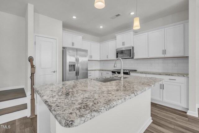 1412 Smoky Mountains St, Durham, NC 27713 - kitchen featuring visible vents, white cabinets, backsplash, and stainless steel appliances