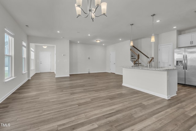 1412 Smoky Mountains St, Durham, NC 27713 - kitchen featuring light wood-style flooring, recessed lighting, stainless steel refrigerator with ice dispenser, and decorative light fixtures