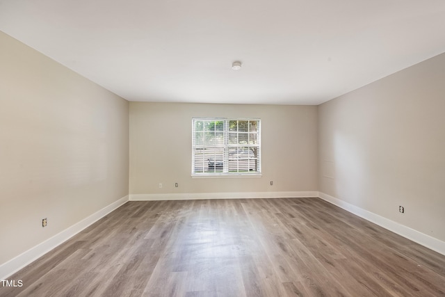 5804 Falls Of Neuse Rd Unit E, Raleigh, NC 27609 - unfurnished room with wood finished floors and baseboards