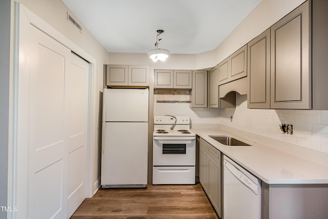 5804 Falls Of Neuse Rd Unit E, Raleigh, NC 27609 - kitchen featuring white appliances, gray cabinets, tasteful backsplash, and light wood-style floors