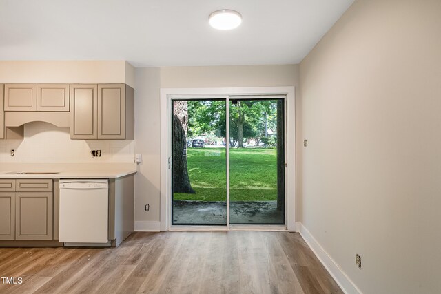 5804 Falls Of Neuse Rd Unit E, Raleigh, NC 27609 - kitchen with dishwasher, light wood-type flooring, backsplash, and light countertops