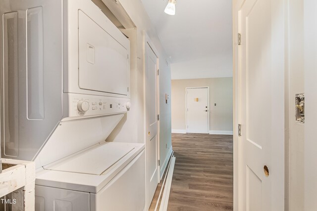 5804 Falls Of Neuse Rd Unit E, Raleigh, NC 27609 - laundry area featuring stacked washer and clothes dryer, wood finished floors, and baseboards