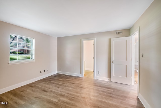 5804 Falls Of Neuse Rd Unit E, Raleigh, NC 27609 - unfurnished bedroom featuring light wood finished floors and baseboards