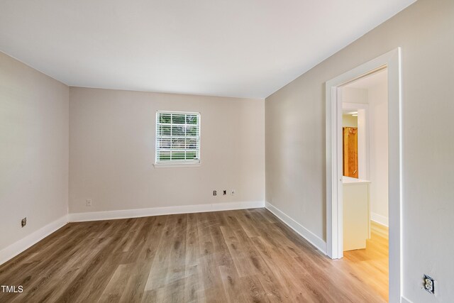5804 Falls Of Neuse Rd Unit E, Raleigh, NC 27609 - empty room with wood finished floors and baseboards