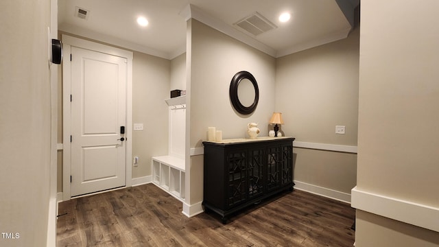 foyer featuring visible vents, baseboards, and wood finished floors