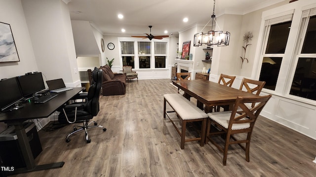 dining area featuring recessed lighting, ornamental molding, wood finished floors, and ceiling fan with notable chandelier