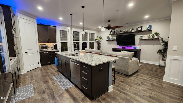 kitchen with dark wood-style flooring, a kitchen island with sink, a breakfast bar, a sink, and dishwasher