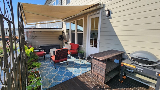 wooden terrace featuring grilling area and a patio area