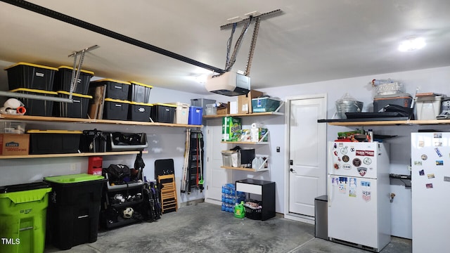 garage with a garage door opener and freestanding refrigerator