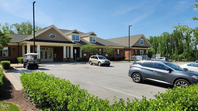 view of building exterior with uncovered parking