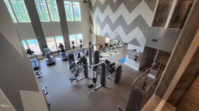 workout area featuring visible vents and a high ceiling