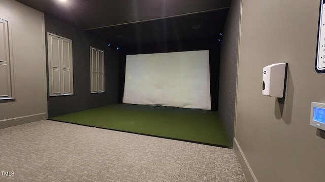 recreation room with baseboards, carpet, and golf simulator