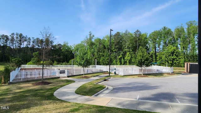 view of home's community featuring fence