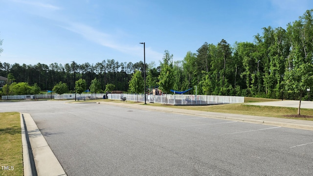 view of street with sidewalks, curbs, and street lights