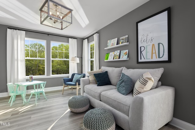 211 Faith Ave, Sanford, NC 27330 - living area featuring baseboards, an inviting chandelier, and wood finished floors