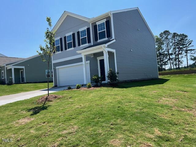 817 Kenyon Springs Dr, Zebulon, NC 27597 - view of front of property with an attached garage, driveway, and a front lawn