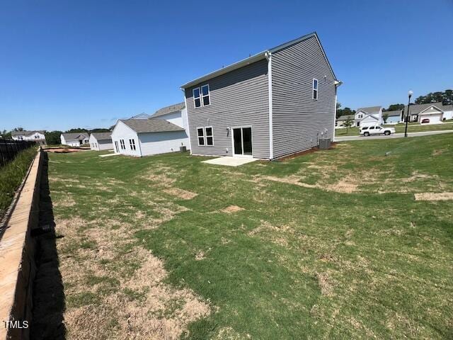 817 Kenyon Springs Dr, Zebulon, NC 27597 - rear view of property with a yard and central AC