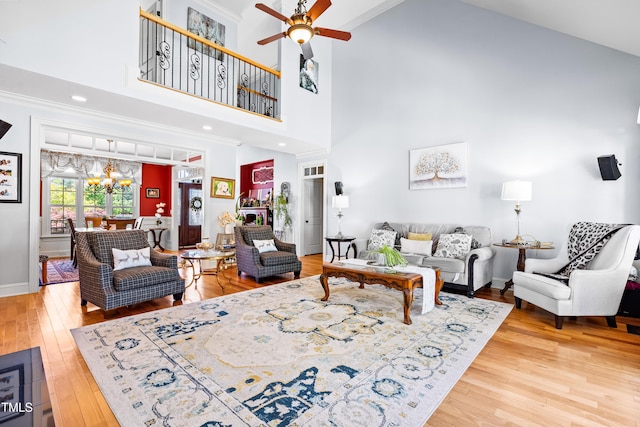 215 Terrell Dr, Rolesville, NC 27571 - living area featuring light wood-style floors, a ceiling fan, a chandelier, crown molding, and baseboards