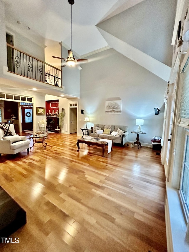 215 Terrell Dr, Rolesville, NC 27571 - living area featuring a towering ceiling, a ceiling fan, wood finished floors, and baseboards