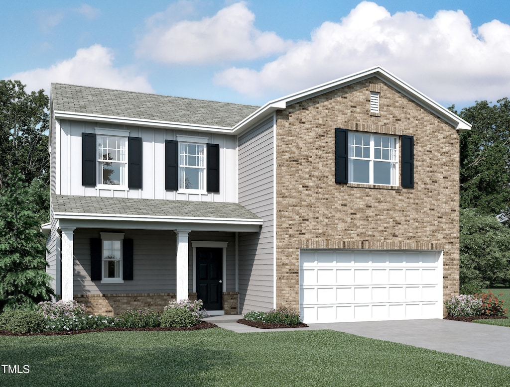 traditional home with roof with shingles, driveway, a front yard, brick siding, and a garage