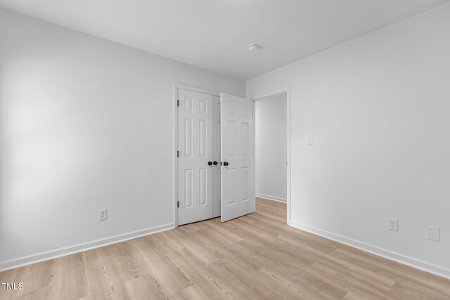 1349 Crabtree Blvd, Raleigh, NC 27610 - unfurnished bedroom featuring a closet, baseboards, and light wood-style floors