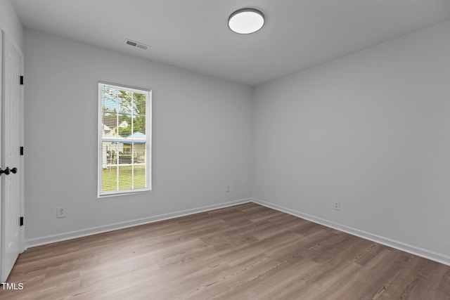 unfurnished room with visible vents, baseboards, and light wood-type flooring