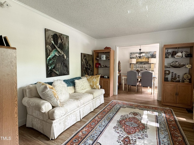 700 Sawmill Rd, Raleigh, NC 27615 - living area with wood finished floors, a textured ceiling, ornamental molding, and an inviting chandelier