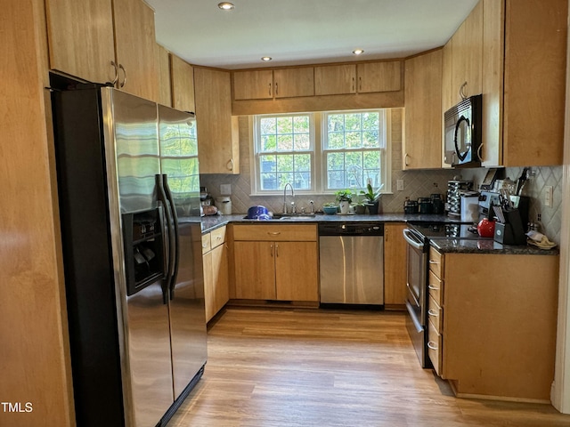 700 Sawmill Rd, Raleigh, NC 27615 - kitchen featuring tasteful backsplash, stainless steel appliances, light wood finished floors, and a sink